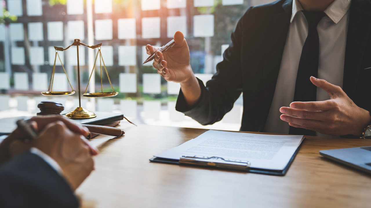 2 people sitting at a legal desk